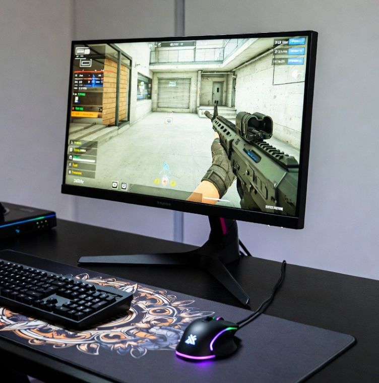 esports gaming desk setup with large mousepad, gaming mouse, and 240Hz monitor displaying CS2 gameplay